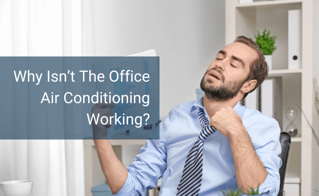 Man sweating in office because the AC isn't working.